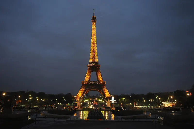 Engineers studying early Eiffel Tower design plans in a nineteenth-century Paris workshop