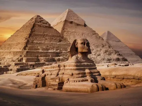 Egyptian pyramids of Giza viewed across the desert plateau at sunrise