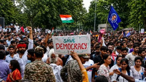 Cockroach protesters gathered near police barricades during the Delhi march toward India’s parliament