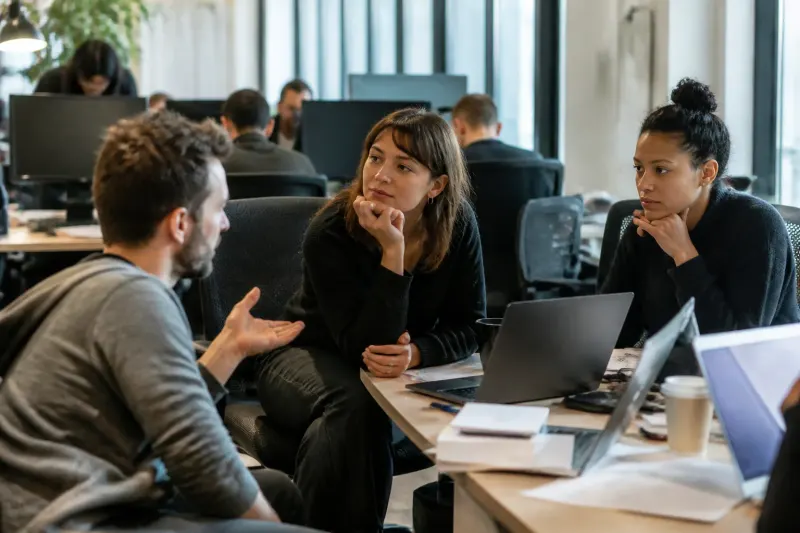 A group of users discussing billing changes in an office setting