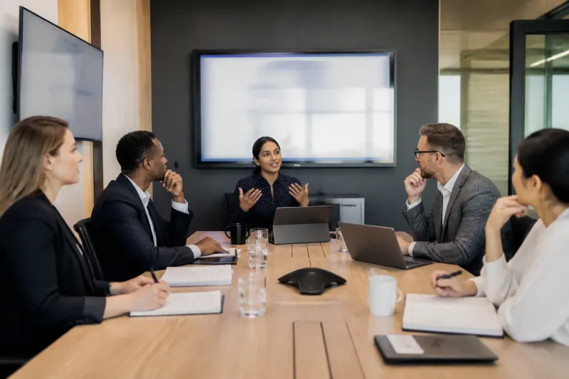Group of engineers and executives gathered for a meeting at EON.