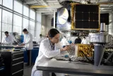 A modern satellite manufacturing facility in California with engineers at work.