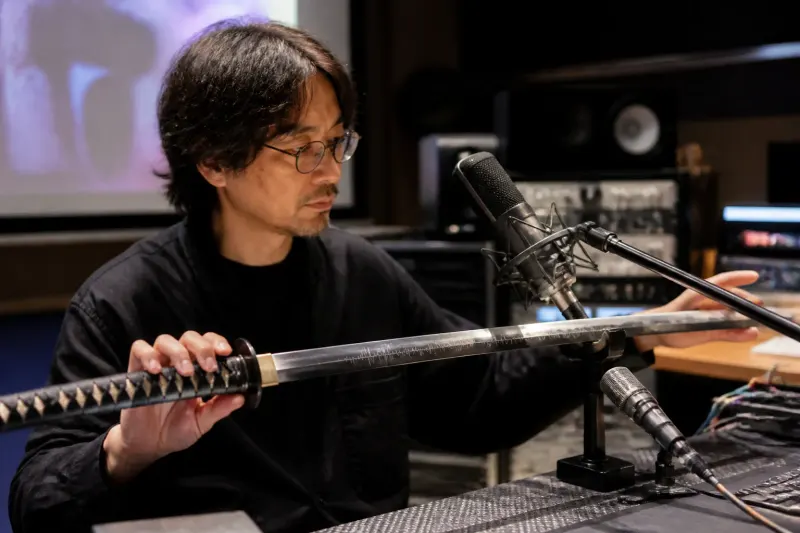 Audio director Shunichi Suwa demonstrating sound effects creation using a special katana.