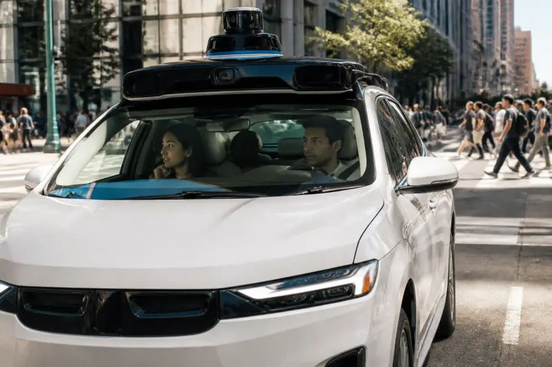 Guident robotaxi navigating urban streets with passengers