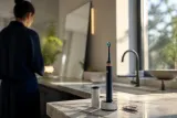Dyson CameraJet toothbrush on a bathroom counter with modern decor