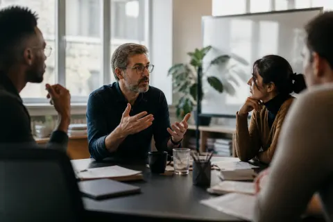 A group of researchers discussing the implications of AI ethics.