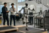 A humanoid robot demonstrating its capabilities in a workshop setting.