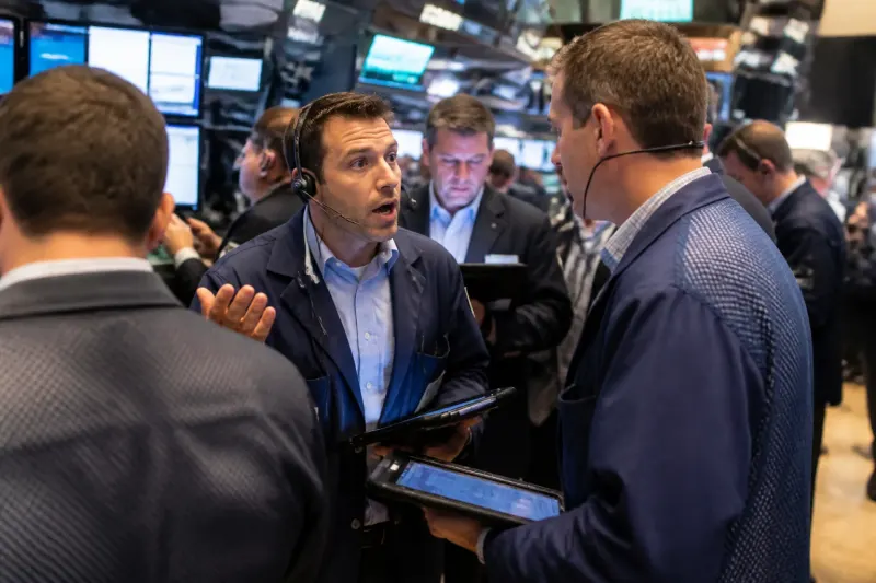 A futures trading floor bustling with traders and screens showcasing live data.