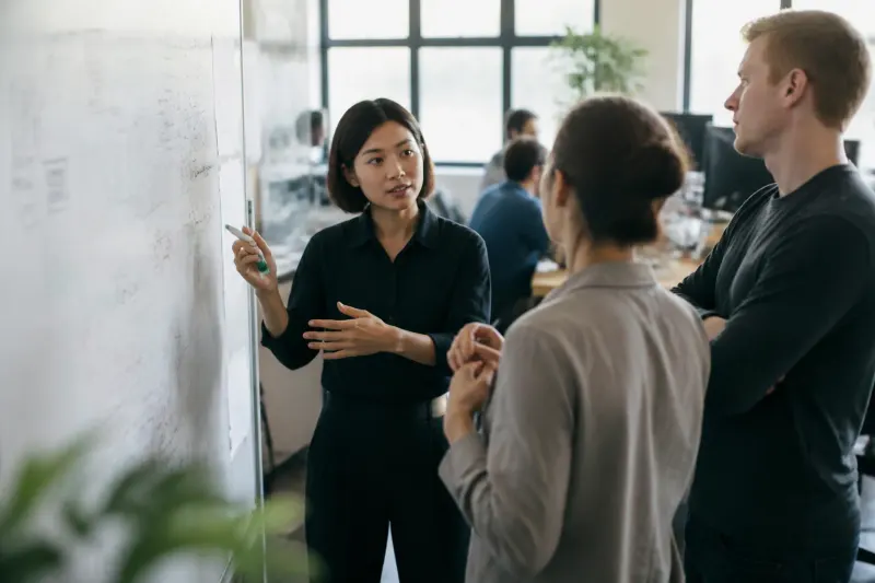 Engineers collaborate on AI memory architecture in a tech workspace.