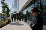 An exterior view of the OpenAI headquarters with a sign visible at the entrance.