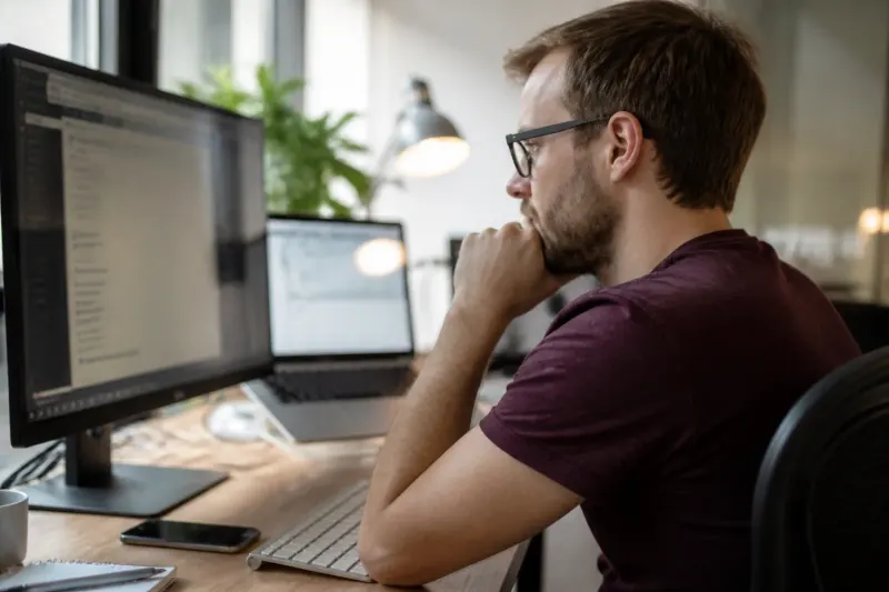 An image depicting a site administrator working on a computer