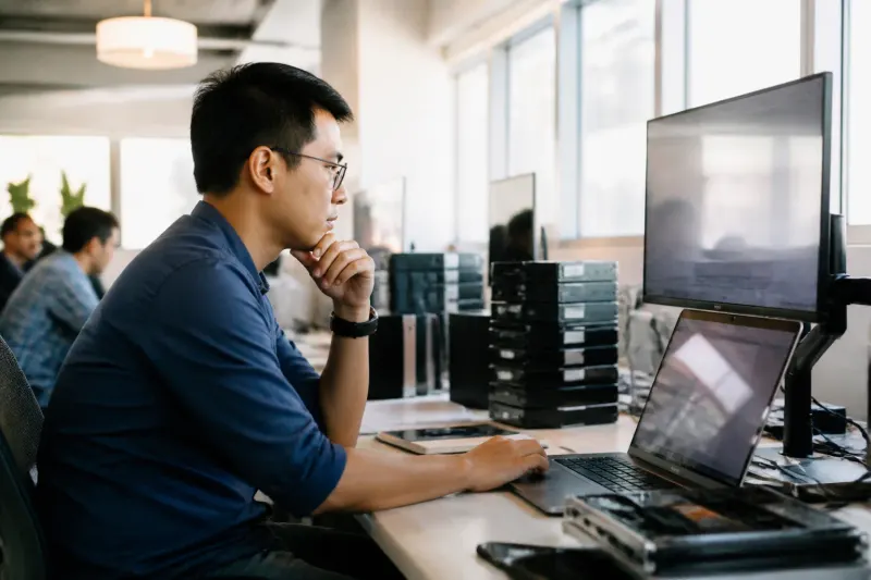 A technician reviewing automation scripts in a modern office environment.