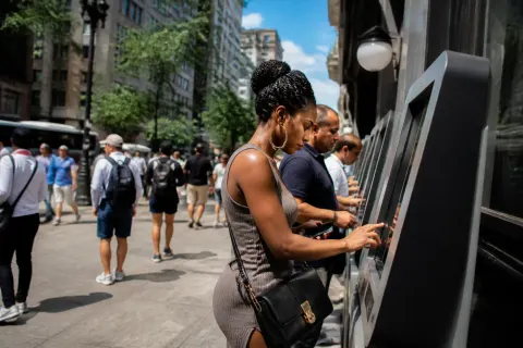 A street view of cryptocurrency kiosks with diverse passersby.