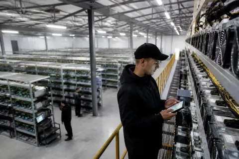 A Bitcoin mining facility with rows of machines running.
