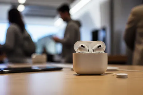 Apple AirPods 5 displayed on a vibrant background