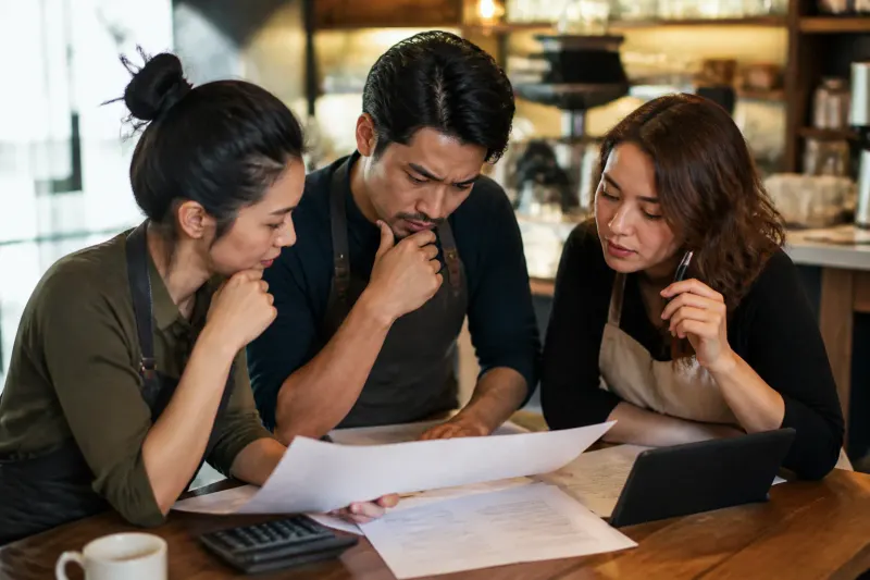 Business owners consulting on tax regulations