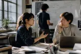 A workshop environment with engineers discussing developments in AI technology.