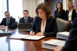 An official signing at the OCC regarding new crypto regulations.