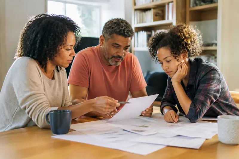 Households discussing budgeting amidst rising bills.