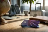 A stack of Delta credit cards on a travel-themed background