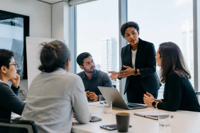 A tech meeting taking place with diverse members collaborating in a conference room