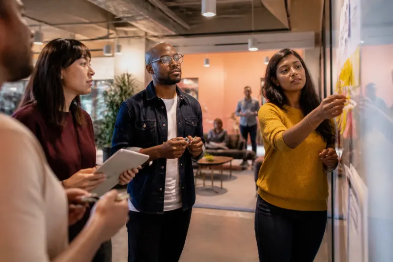 Teams collaborating around a table at Microsoft office