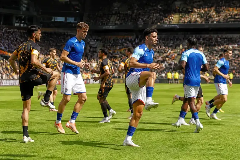 Two football teams warming up on the pitch before the match.